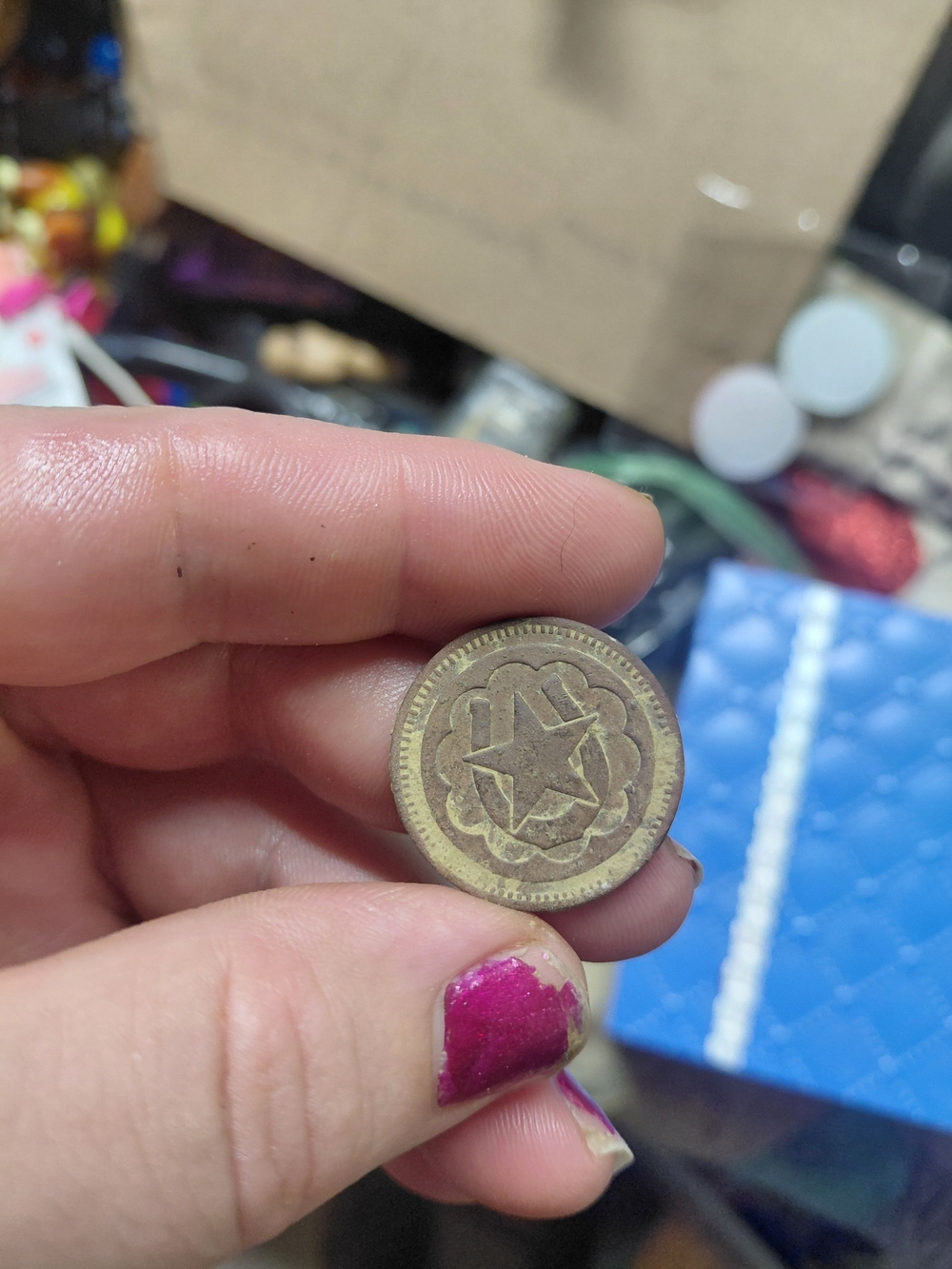 vintage "No Cash Value" good luck token featuring a horseshoe and star design.
